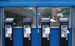 amano-mcgann-case-study Daytime view of four solar-powered parking meters in an open-front kiosk
