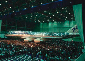 A Boeing jetliner is revealed at an indoor media event