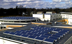 natick-case-study Daytime aerial view of solar panels on the roof of a public school in Natick, Massachusetts