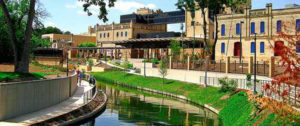 Daytime view of a corner of San Antonio, Texas with the river in the foreground