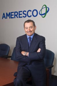 Portrait of George Sakellaris in the boardroom of Ameresco