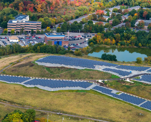 Daytime aerial view of a municipal landfill solar farm in Lowell developed by Ameresco
