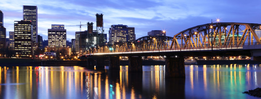 Evening view of Portland, Orgegon with a the Broadway Bridge in the foreground.