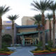 Daytime exterior of the main entrance of University Medical Center of Southern Nevada, flanked by palm trees