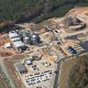 Daytime aerial view of the Department of Energy Savannah River Site Biomass Cogeneration Facility and its surrounding buildings and storage areas