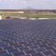 Daytime view of solar panels on the roof of St. Paul International Airport, with the City of Minneapolis on the horizon