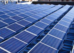 Daytime view of solar panels on the roof of a school building in Natick, Massachusetts