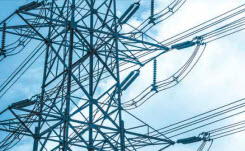 energy-supply-management-245-151 Daytime close-up view of a high voltage power line transmission tower against a blue sky