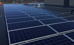 Daytime view of solar panels installed on the roof of a school in Braintree, Massachusetts
