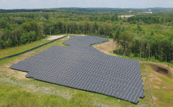 blue-cross-blue-shield-case-study-thumb Daytime aerial view of a Blue Cross Blue Shield of Massachusetts solar farm in a wooded area