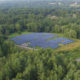 Daytime aerial view of a brownfield solar farm in Stockbridge.