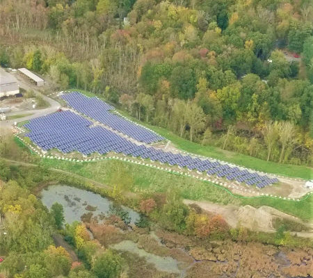 Daytime aerial view of the Sympaug landfill solar project in Bethel