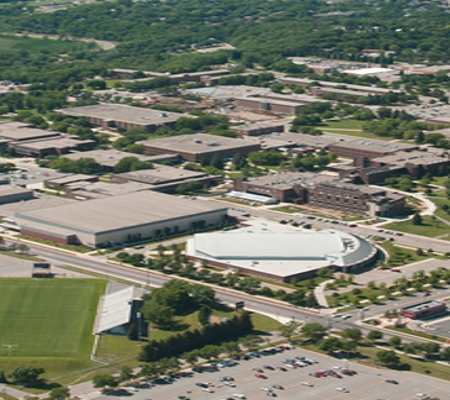 Daytime aerial view of Minnesota State University Mankato showing the football field and Bresnan Arena.