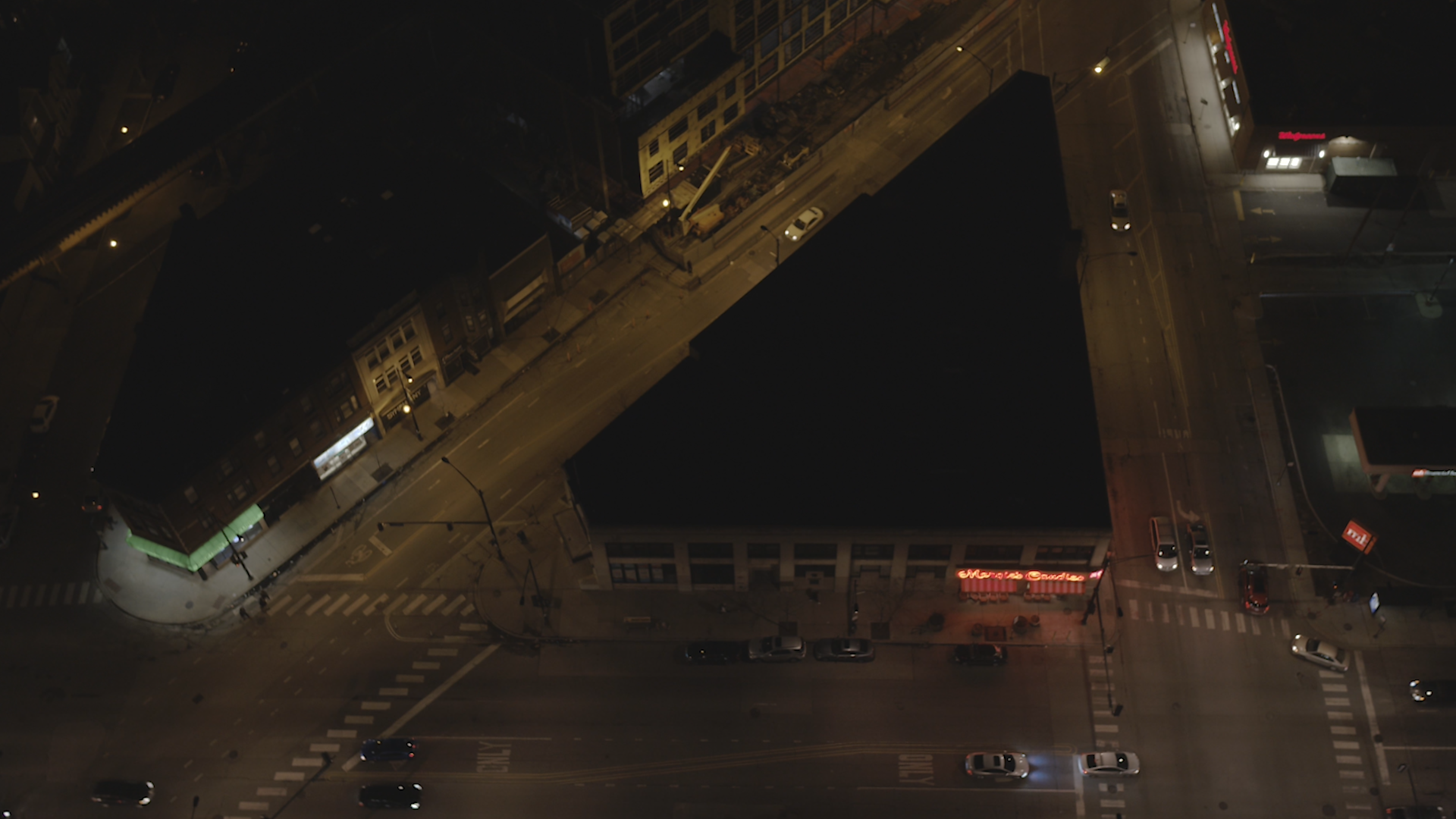 Aerial view of a Chicago city block at night showing poor lighting.