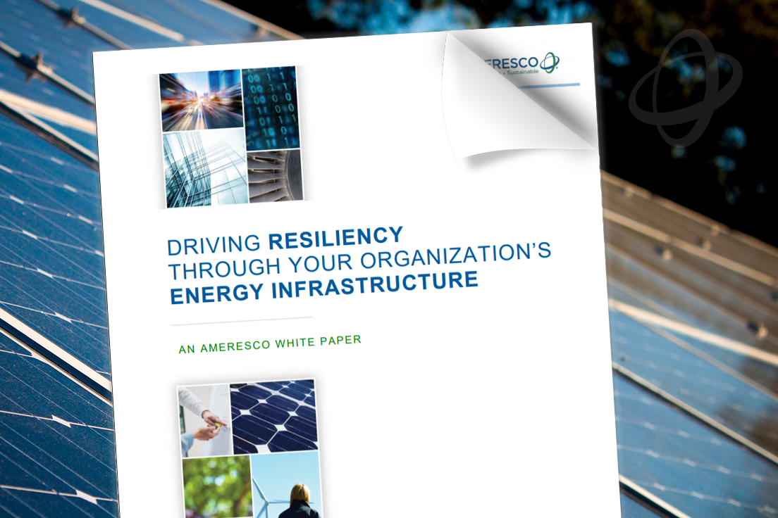 The cover of Ameresco's free energy resiliency white paper superimposed over a daytime view of solar panels.