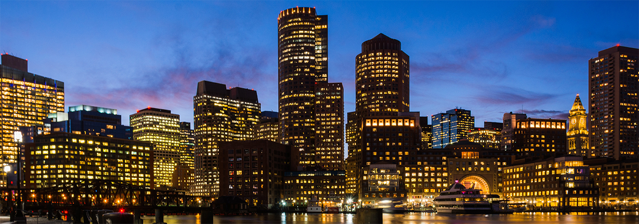 Nighttime panoramic view of a city as seen from the water