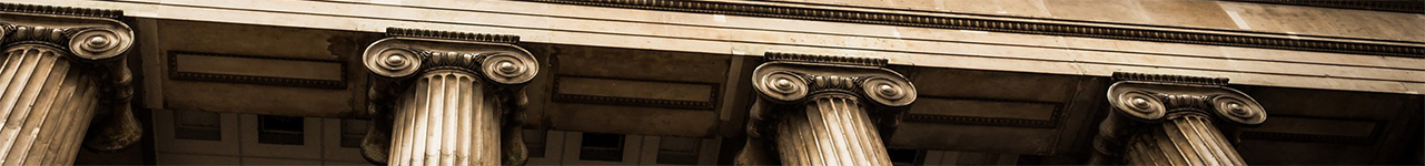 Close up view of ionic columns supporting a stone roof