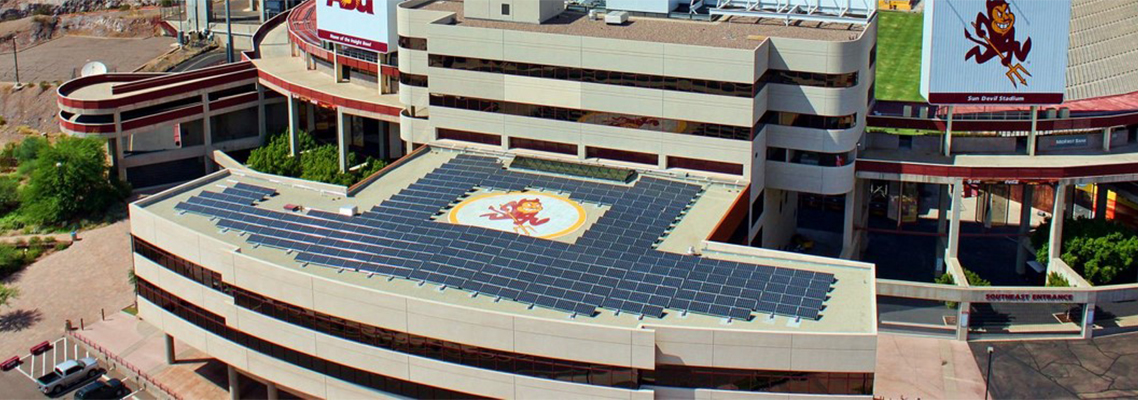 Daytime aerial view of the student center and stadium at Arizona State University, showing solar panels on the roof.