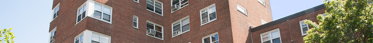 Daytime view of a multistory public housing building.