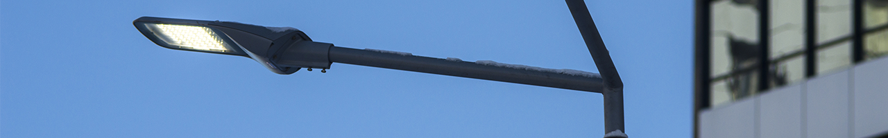 Close up view of an LED street light in front of a building