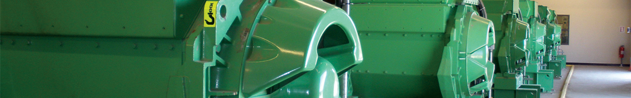 Close up view of a row of five green-painted cogeneration energy generators