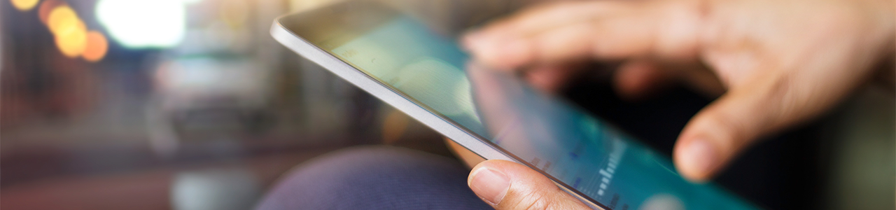 Interior close up shows someone holding a tablet computer and reviewing data