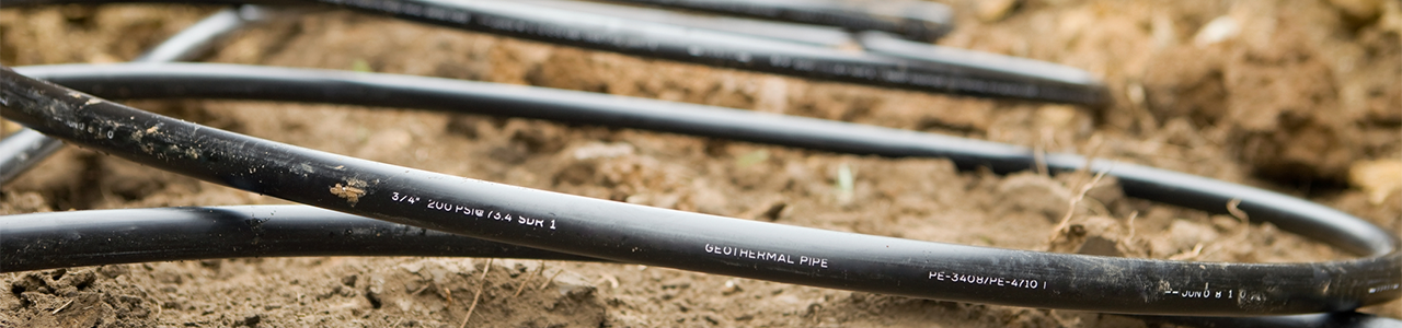 Daytime view of geothermal piping in a trench