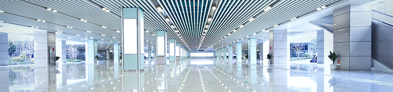 Interior view of a modern building lobby lit with overhead and panel LED lighting