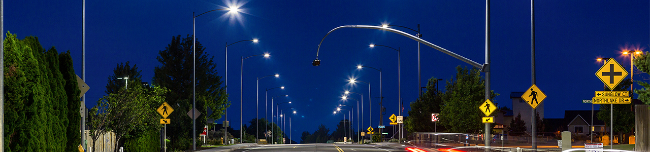 Evening view of LED street lights along a road stretching into the distance