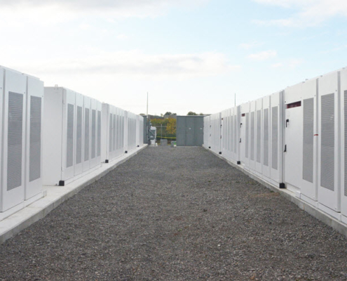 Daytime exterior view from between two rows of enclosures at the Newmarket, Ontario battery energy storage system