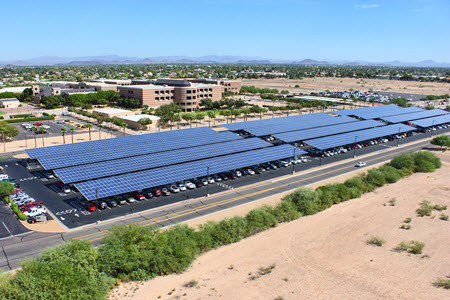 Daytime aerial view of large solar car port canopies on the campus of Arizona State University