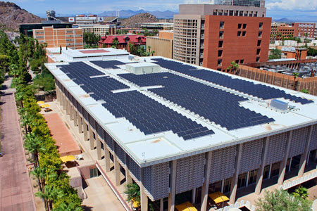 Daytime view of solar panels on the roof of a building on the Arizona State University campus