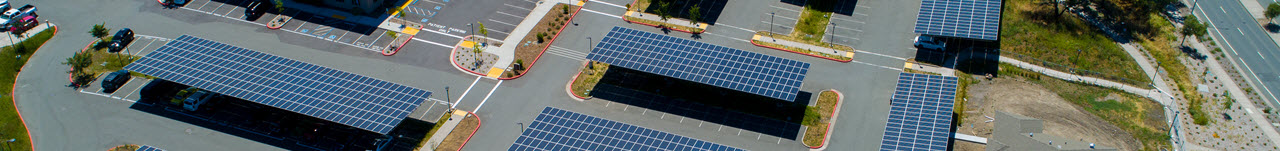 Daytime aerial view of solar canopies in a parking lot