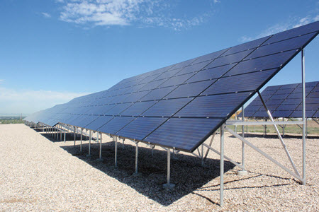 Daytime view of solar panels mounted in an array at a solar farm