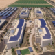 A daytime aerial view of a corporate campus in Chandler with renderings of rooftop solar panels and solar canopies added