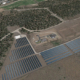 Daytime aerial view of land near Rocky Mountain College with rendered solar panels