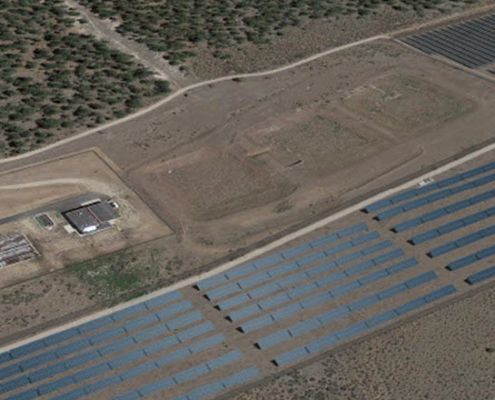 Daytime aerial view of land near Rocky Mountain College with rendered solar panels