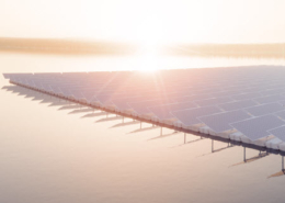 The sun sets behind a lake with a floating solar-panel farm