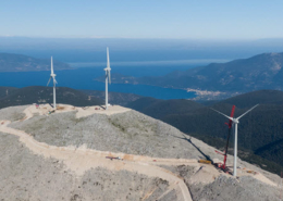 Daytime aerial view of wind turbines on a hilltop in Kefalonia, Greece