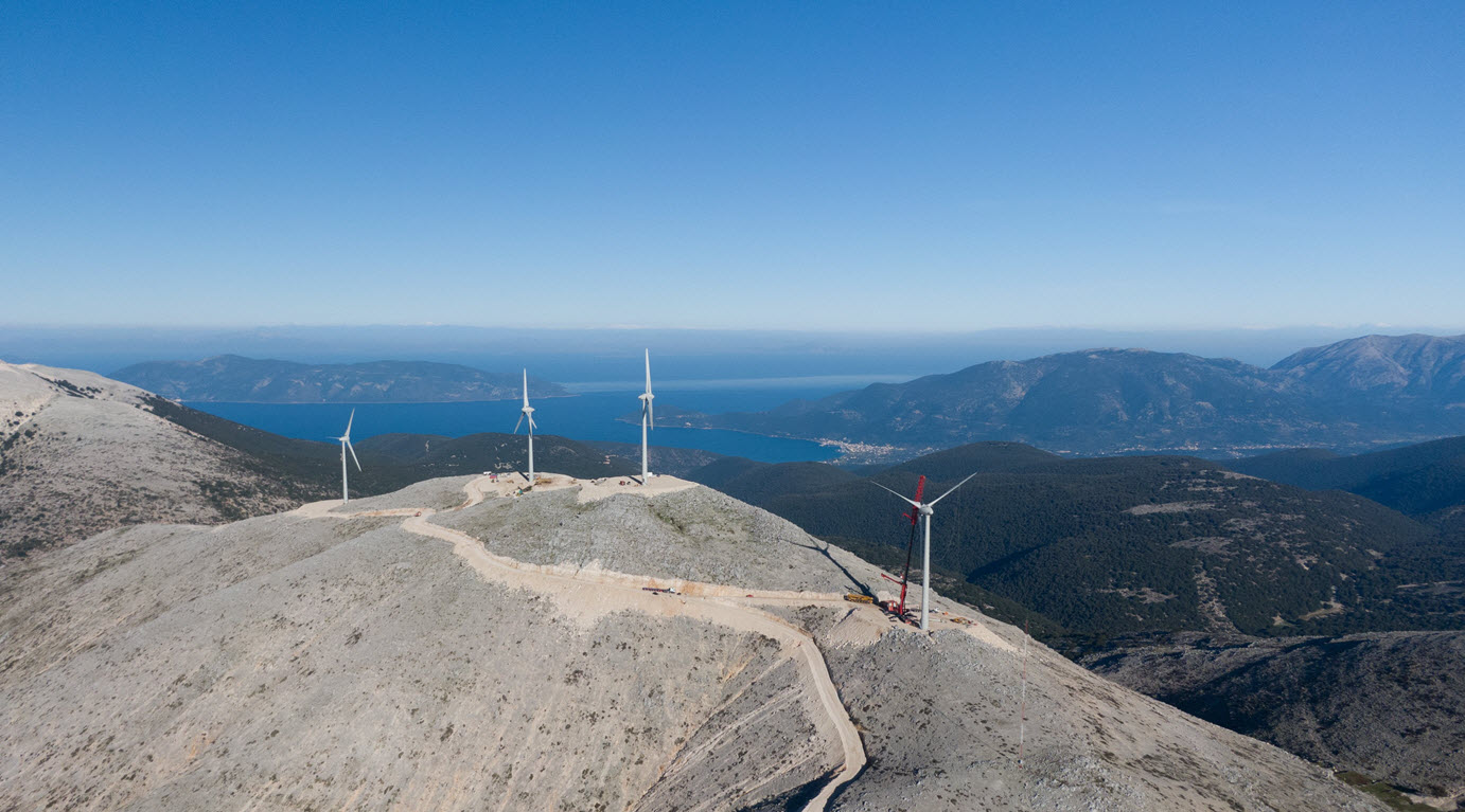 Daytime aerial view of wind turbines on a hilltop in Kefalonia, Greece