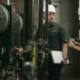 Interior view of a man and woman in hard hats inspecting central plant equipment