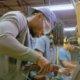 Interior view of workers inspecting and maintaining central plant equipment