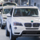 Interior view of a BMW assembly line building white SUVs