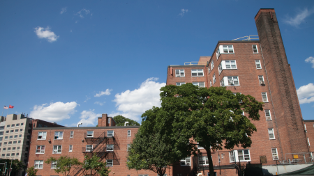 Daytime exterior view of multifamily housing buildings owned by the Boston Housing Authority