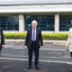 Daytime view of two Carmarthenshire representatives and an Ameresco employee in a Carmathenshire parking lot