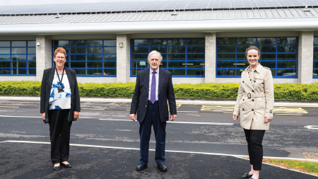 Daytime view of two Carmarthenshire representatives and an Ameresco employee in a Carmathenshire parking lot
