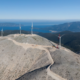 Daytime aerial view of wind turbines on a hilltop in Kefalonia, Greece