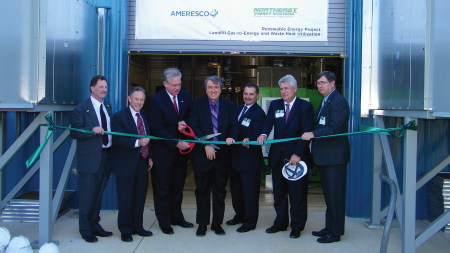 Daytime view of officials cutting a ribbon at the opening of an energy facility at the Jefferson County Landfill