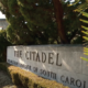 Daytime close up view of a sign at the entrance of The Citadel