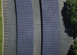 Daytime aerial view of solar car ports in a parking lot at the University of Minnesota Twin Cities campus